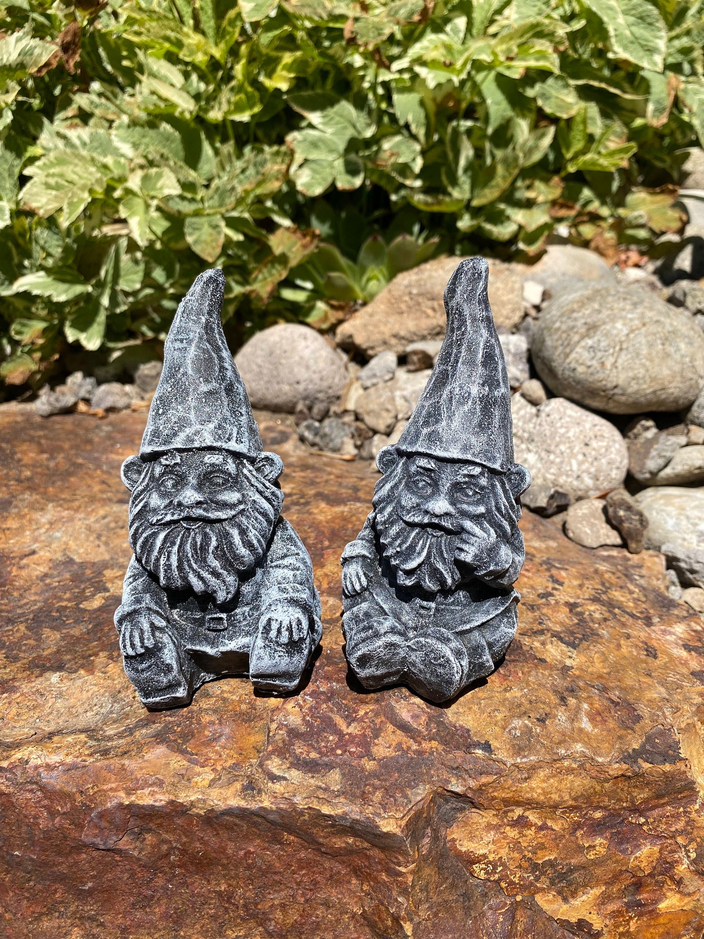 Handmade cement gnome pair for garden decor, featuring unique expressions and crafted with care in Idaho, USA.