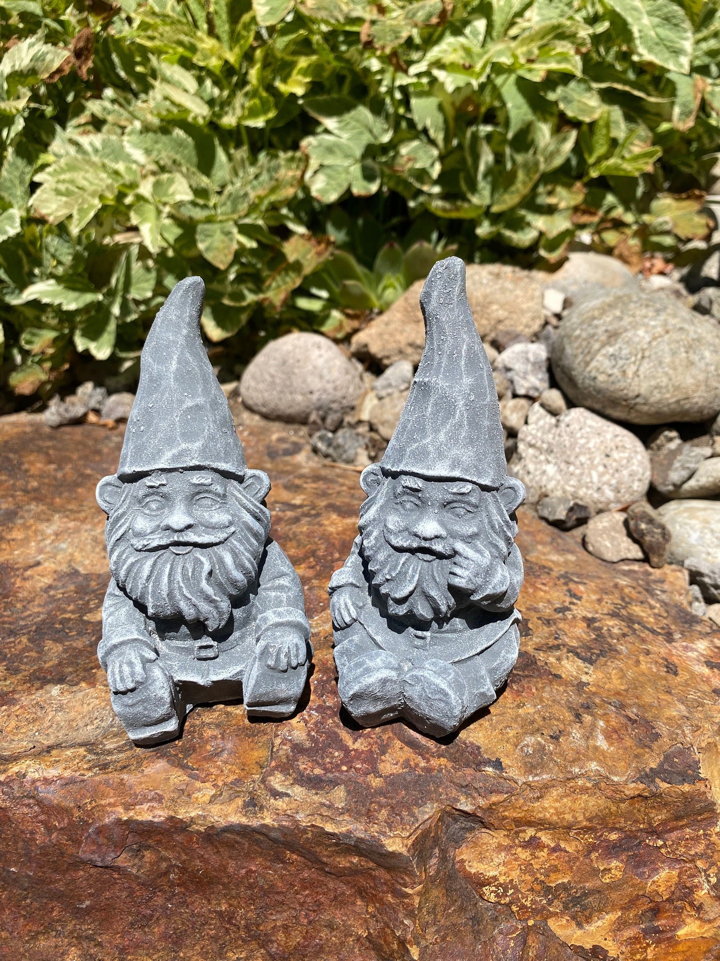 Handmade cement gnome pair for garden decor, featuring unique expressions and crafted with care in Idaho, USA.