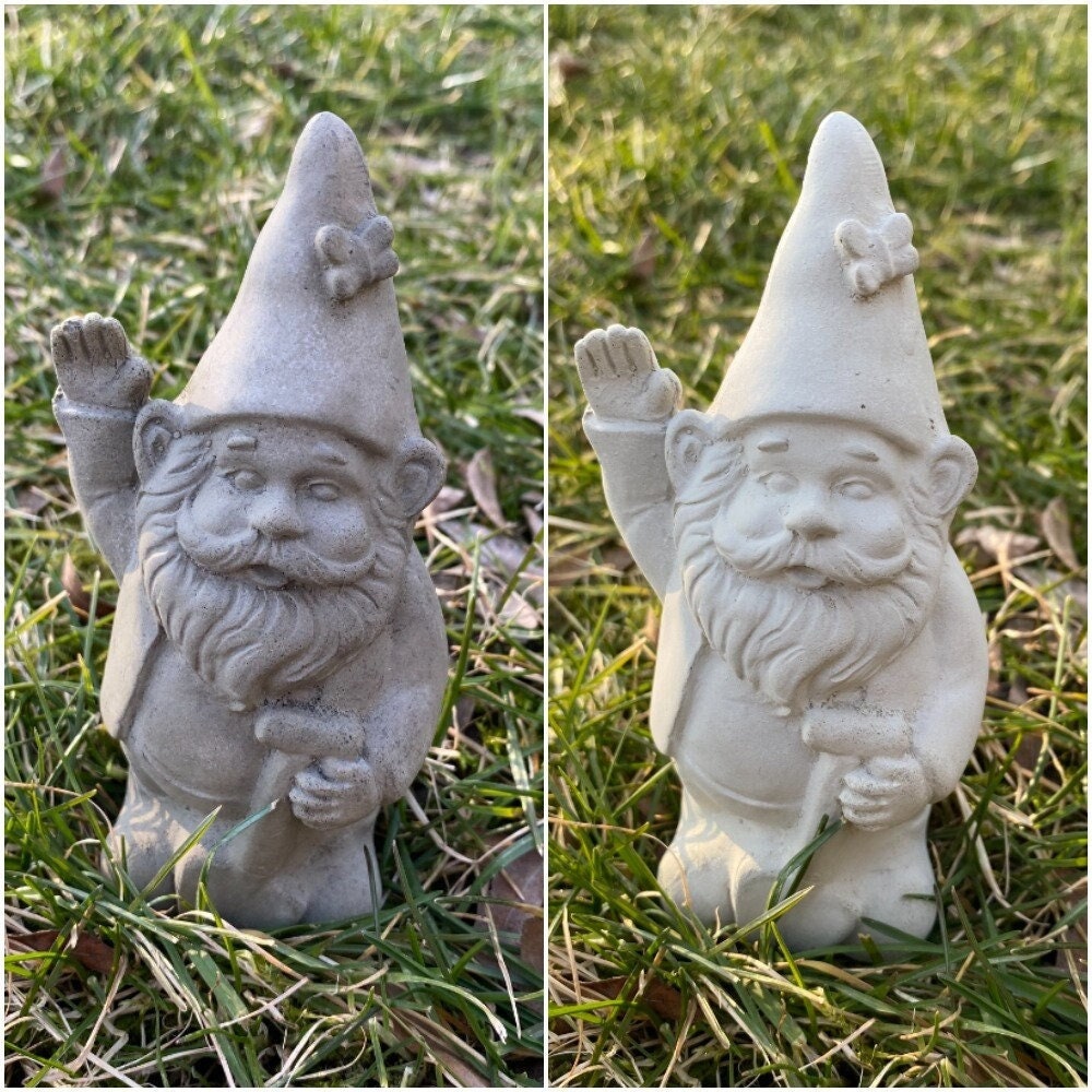 A cute garden gnome holding a shovel, perfect for yard and patio decor