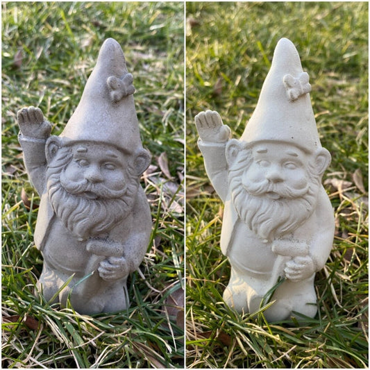 A cute garden gnome holding a shovel, perfect for yard and patio decor