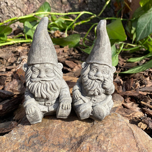 Handmade cement gnome pair for garden decor, featuring unique expressions and crafted with care in Idaho, USA.
